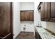 Laundry room with tile floors, wood cabinets and granite counter top at 2300 E Sanoque Ct, Gilbert, AZ 85298