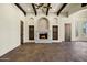 Elegant living room showcasing a stone fireplace, beamed ceilings, and rich tile flooring at 2300 E Sanoque Ct, Gilbert, AZ 85298