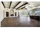 Living room with stone fireplace, wood beams, and views to the backyard at 2300 E Sanoque Ct, Gilbert, AZ 85298