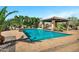 Beautiful pool area, featuring a covered outdoor kitchen and a surrounding patio area at 2300 E Sanoque Ct, Gilbert, AZ 85298