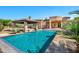 Inviting backyard pool and covered patio area, perfect for outdoor entertaining and relaxation at 2300 E Sanoque Ct, Gilbert, AZ 85298