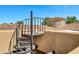 Close-up view of spiral staircase leading to the rooftop with terracotta roofing at 2300 E Sanoque Ct, Gilbert, AZ 85298