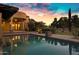 Inviting pool area with lush landscaping, elegant home facade, and serene atmosphere at 2300 E Sanoque Ct, Gilbert, AZ 85298
