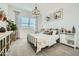 Stylish bedroom with an iron frame bed, neutral colors, and carpet flooring at 23038 E Nightingale Rd, Queen Creek, AZ 85142