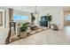 Bright living room featuring a large sectional, modern lighting, and backyard views at 23038 E Nightingale Rd, Queen Creek, AZ 85142