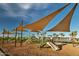The modern playground has multiple slides, shade and lots of play space at 23038 E Nightingale Rd, Queen Creek, AZ 85142