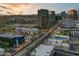 Scenic aerial view highlighting the downtown area with bustling streets and various commercial buildings at twilight at 2323 N Central Ave # Ph D, Phoenix, AZ 85004