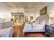 Luxurious bedroom with wood floors, a comfortable lounge chair, and neutral decor at 2323 N Central Ave # Ph D, Phoenix, AZ 85004