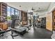Well-equipped gym with modern fitness equipment, built-in bookshelves, and mirrored wall at 2323 N Central Ave # Ph D, Phoenix, AZ 85004
