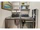 Modern laundry room featuring stainless steel front-loading washer and dryer with shelving and organized storage solutions at 2323 N Central Ave # Ph D, Phoenix, AZ 85004