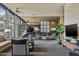 Relaxing lounge area featuring a grand piano, comfortable seating, large windows, and a modern television at 2323 N Central Ave # Ph D, Phoenix, AZ 85004