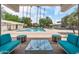 Community pool with lots of lounge chairs, umbrellas, and lush tropical landscaping at 2323 N Central Ave # Ph D, Phoenix, AZ 85004