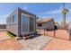 Container home in a backyard, complete with modern amenities, a private patio, and secure fencing at 2327 E Pebble Beach Dr, Tempe, AZ 85282