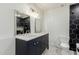Modern bathroom with dual sinks, stylish vanity, and a decorative black and white tile accent wall at 2327 E Pebble Beach Dr, Tempe, AZ 85282