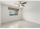 Bright bedroom with tile floors, ceiling fan, and a window with a woven shade at 2327 E Pebble Beach Dr, Tempe, AZ 85282