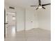 Well-lit bedroom with neutral tile flooring, a ceiling fan, and fresh paint at 2327 E Pebble Beach Dr, Tempe, AZ 85282