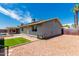 Rear exterior view of a single-story home with a patio, pool, desert landscaping, and an artificial turf area at 2327 E Pebble Beach Dr, Tempe, AZ 85282