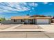 Charming single-story home featuring a two-car garage and xeriscaped front yard for low maintenance appeal at 2327 E Pebble Beach Dr, Tempe, AZ 85282