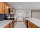 Stylish kitchen featuring modern appliances, white countertops, wooden cabinets, and direct access to backyard at 2327 E Pebble Beach Dr, Tempe, AZ 85282