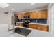 Modern kitchen with stainless steel appliances, quartz countertops, tile backsplash, and wood cabinets at 2327 E Pebble Beach Dr, Tempe, AZ 85282