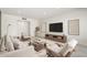 Bright living room with modern furnishings, neutral decor, and a sleek entertainment center at 2327 E Pebble Beach Dr, Tempe, AZ 85282