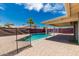 Inviting pool area with a safety fence, brick patio, and covered space for outdoor enjoyment at 2327 E Pebble Beach Dr, Tempe, AZ 85282
