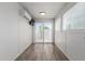 Bright room with wood-look floors, a sliding glass door, and mini-split air conditioning at 2327 E Pebble Beach Dr, Tempe, AZ 85282