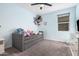 Bedroom with light blue walls, gray carpet, trundle bed, and a net full of toys at 235 S 190Th Ave, Buckeye, AZ 85326
