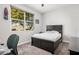 Cozy bedroom featuring neutral carpet, a black bed frame, and a large window offering natural light at 235 S 190Th Ave, Buckeye, AZ 85326