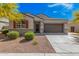 Charming single-story home with a well-maintained front yard, two-car garage and inviting entryway at 235 S 190Th Ave, Buckeye, AZ 85326