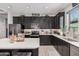 Stylish kitchen featuring dark cabinetry, quartz countertops, stainless steel appliances, and a center island at 235 S 190Th Ave, Buckeye, AZ 85326