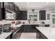 Contemporary kitchen with stainless steel appliances, sleek dark cabinets, and bright white subway tile backsplash at 235 S 190Th Ave, Buckeye, AZ 85326
