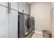 Modern laundry room featuring stainless steel washer and dryer, complemented by white cabinets for ample storage at 235 S 190Th Ave, Buckeye, AZ 85326
