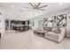 Large living space featuring a modern sofa, sleek flooring and a seamless transition to the kitchen at 235 S 190Th Ave, Buckeye, AZ 85326