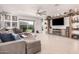 Open living room boasting a large sectional, mounted television, decorative shelving, and backyard access at 235 S 190Th Ave, Buckeye, AZ 85326