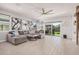 Spacious living room featuring neutral tones, large windows, modern tile floors and sliding glass doors at 235 S 190Th Ave, Buckeye, AZ 85326