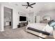 Bright main bedroom with a ceiling fan, ensuite bathroom, and access to the closet at 235 S 190Th Ave, Buckeye, AZ 85326