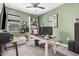 Well-lit home office featuring modern desk, shelving, and comfortable seating area with stylish decor at 235 S 190Th Ave, Buckeye, AZ 85326