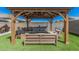 Outdoor pergola with comfortable seating and artificial turf, perfect for entertaining or relaxing in style at 235 S 190Th Ave, Buckeye, AZ 85326