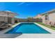 Sparkling pool surrounded by low-maintenance artificial turf, complemented by patio furniture for ultimate relaxation at 235 S 190Th Ave, Buckeye, AZ 85326