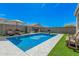 Backyard pool with stylish patio furniture, perfect for enjoying sunny days and entertaining guests in the backyard at 235 S 190Th Ave, Buckeye, AZ 85326