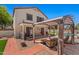 Covered patio seating and a lush backyard with a sparkling pool in this lovely desert home at 2454 W Camp River Rd, Queen Creek, AZ 85144