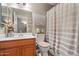 Clean, well-maintained bathroom with a single sink vanity and shower with curtain at 2454 W Camp River Rd, Queen Creek, AZ 85144