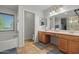Well-lit bathroom with double sink vanity and large soaking tub at 2454 W Camp River Rd, Queen Creek, AZ 85144