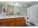 This bathroom has a double-sink vanity, a large mirror, and a shower/tub combo at 2454 W Camp River Rd, Queen Creek, AZ 85144