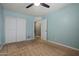 This bedroom has a ceiling fan, neutral-toned walls and a closet with bright natural light at 2454 W Camp River Rd, Queen Creek, AZ 85144