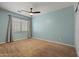 This bedroom has neutral-toned walls, carpet flooring and a bright window bringing in plenty of natural light at 2454 W Camp River Rd, Queen Creek, AZ 85144