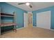 This bedroom features a ceiling fan, a closet, and a built-in desk with shelving for added functionality at 2454 W Camp River Rd, Queen Creek, AZ 85144