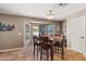 Cozy dining room features large windows, comfortable seating, and a stylish ceiling fan at 2454 W Camp River Rd, Queen Creek, AZ 85144