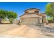 Charming two-story home featuring a two-car garage and desert landscaping at 2454 W Camp River Rd, Queen Creek, AZ 85144